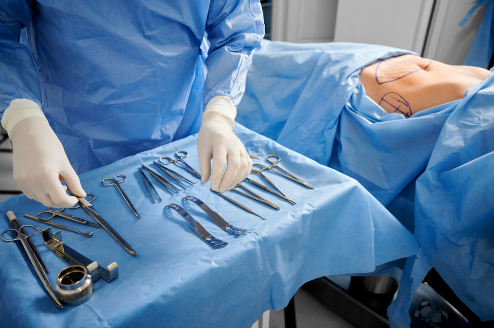 Surgeon preparing to perform liposuction procedure